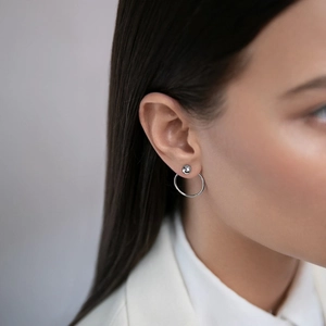 Close-up of minimalist S925 sterling silver hoop earrings set with zircons on model