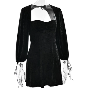 Detail of black velvet mini dress featuring corset style bodice and puff sleeve cuff ties