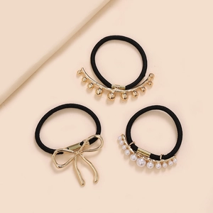 Set of 3 elegant hair ties featuring golden bow, beads, and faux pearls on black bands