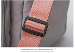 Detail of adjustable pink nylon shoulder strap with durable plastic buckle on gym bag