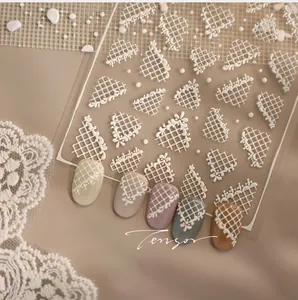 Detailed 5D embossed white lace and grid nail art stickers on various colored nails