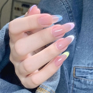 Close-up of almond-shaped French nails with multi-color pastel tips on pink base