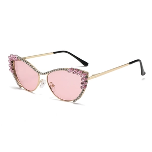 Elegant cat eye sunglasses with pink lenses and sparkling crystal-encrusted gold metal frames