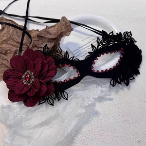 Elegant vintage black lace masquerade mask with large red flower and ruby rhinestones