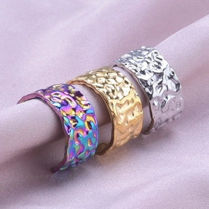 Detailed view of hammered stainless steel adjustable rings on soft silk fabric