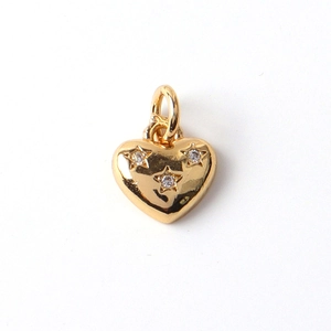 Macro shot of gold-plated heart pendant with star-set cubic zirconia and polished finish