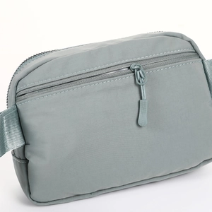 Close-up of the grey-blue sports fanny pack showing fabric texture and zipper detail