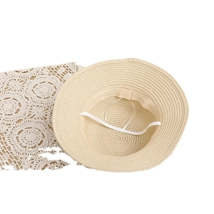 Straw sun hat for kids featuring a tight weave pattern and adjustable white chin strap