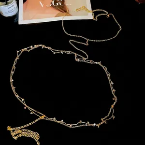 Elegant multi-layer gold body chain with zircon beads and tassels on black background