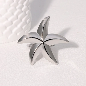 Minimalist silver starfish ring in stainless steel with a polished metallic finish