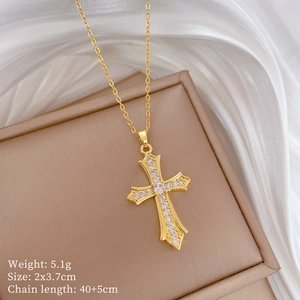 Close-up of gold cross pendant with cubic zirconia and dimensions: 5.1g, 2x3.7cm