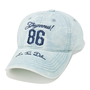 Macro detail of number 86 embroidery on light blue washed denim baseball cap