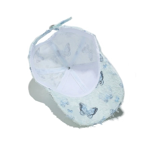 Detail of light blue butterfly lace baseball cap showing internal lining and metal buckle