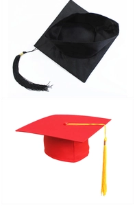 Detail view of academic graduation caps in black and red with high-quality silk tassels