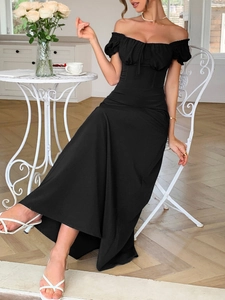 Dettaglio di un elegante abito lungo nero con spalle scoperte, maniche a sbuffo e corsetto