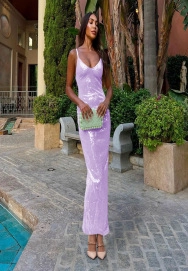 Detail shot of shimmering purple sequins on a long backless evening dress with slim straps