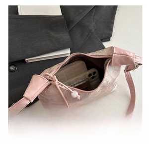 Pink silk embroidery handbag detail showing internal capacity for phone and wallet