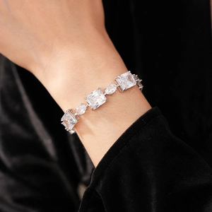 Detail of silver bracelet with square and oval cubic zirconia stones on black velvet