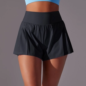Détail d'une jupe-short de sport noire plissée à taille haute avec contrôle du ventre