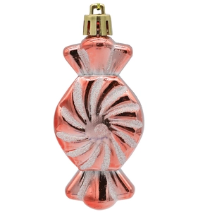 Close-up of pink candy-shaped Christmas ornament with white glitter spiral patterns