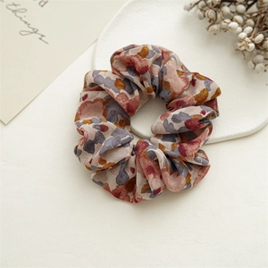 Detailed shot of floral print scrunchie texture on white stone tray with decor