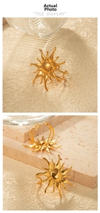 Detail showing golden sunburst open ring with radiant lines and polished center bead