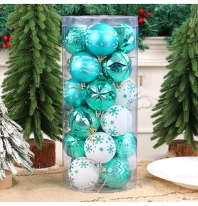 Detail of teal and white Christmas ball ornaments with snowflake patterns in a clear cylinder
