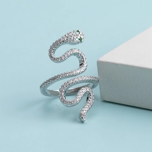 Silver snake wrap ring with sparkling white cubic zirconia and emerald green stone eyes