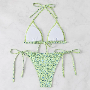 Detailed flat lay of green floral bikini set with halter top and side-tie bottoms