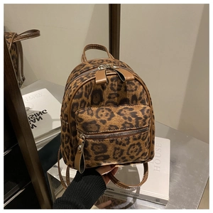 Detailed macro view of the leopard print faux fur texture and leather zipper puller
