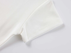 Close-up of sleeve stitching and modal fabric texture on white crewneck athletic t-shirt
