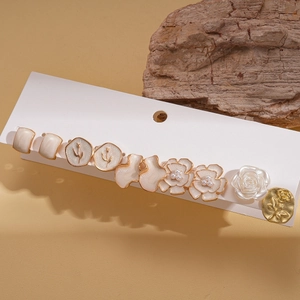 Detail of 6 pairs vintage style floral resin and gold plated earrings on display