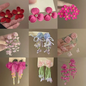 Collection of floral pearl earrings in various colors like red pink and purple