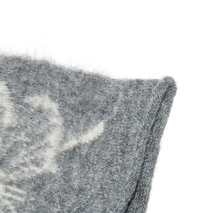 Macro shot of gray knitted wool hat texture featuring soft mohair fibers and weave detail