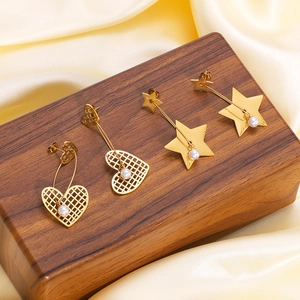 18k gold plated stainless steel heart and star earrings with white pearls on wood display