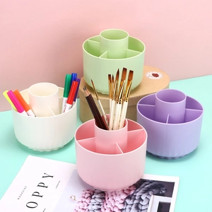 Rotating desktop organizer for pens and brushes in pastel green, white, pink, and purple