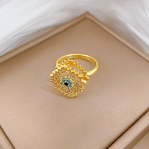 Detail of a rotating golden Evil Eye ring featuring sunburst design and micro-inlaid zircons