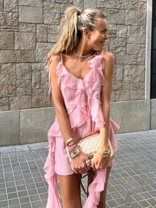 Detailed macro shot of the pink ruffles and wrinkled linen texture on this summer top