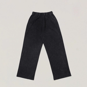 Close-up of dark grey straight-leg joggers showing detailed waffle-knit fabric texture