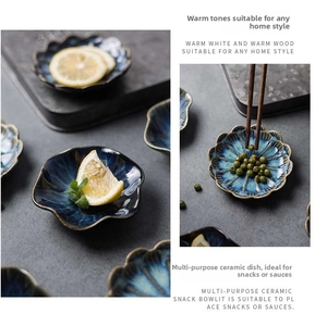 Detail of blue kiln-fired petal ceramic dish with vintage brown rim and rustic glaze