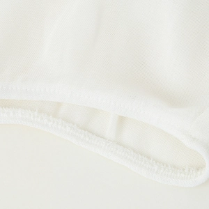Close-up of elegant white ruffled V-neck shirt in breathable mesh fabric with ruffle trim