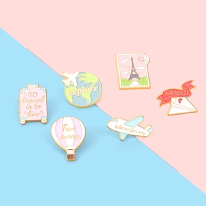 Travel-themed enamel brooch set with airplane, suitcase, globe and hot air balloon designs