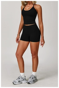 Women's black halter neck yoga set with high waist compression shorts for fitness