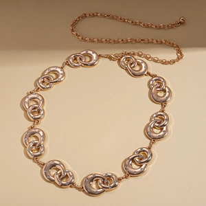 Detail of rose gold geometric interlocking ring waist chain with shimmering rhinestones