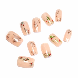 Short square press-on nails with red berry leaf designs and gold foil butterfly accents