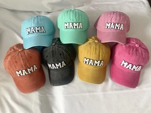 Flat lay of colorful washed cotton baseball caps with MAMA chenille embroidery patches