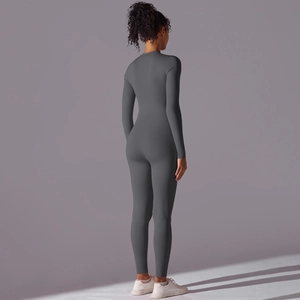 Rear view of sleek dark grey long sleeve yoga jumpsuit showing fit and back curves