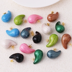 Flat lay of colorful teardrop stud earrings in eight vibrant resin finishes with metal posts