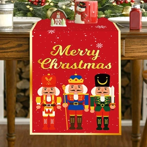 Christmas Nutcracker table runner with Merry Christmas text on wooden dining table