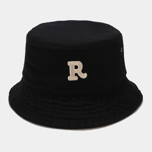 Close-up of the premium black cotton bucket hat featuring a white embroidered letter R